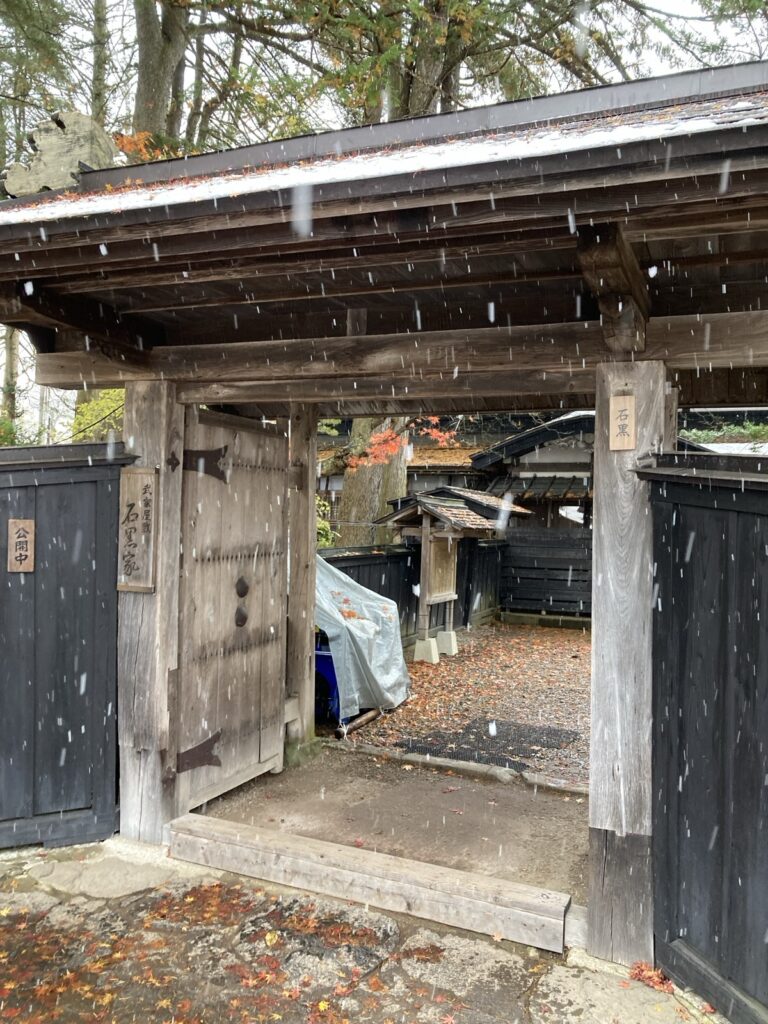 「公開中」の札がかかった石黒家の門